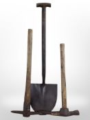 A vintage spade and two pickaxes.