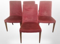 A set of four G Plan chairs on tapering teak legs, in red upholstery.