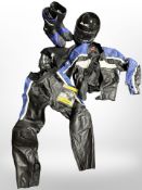 A motorbike helmet, pair of riding boots, and motorbike leathers.