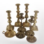 A collection of brass candlesticks.