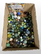 A collection of mainly glass marbles.