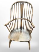 An Ercol stained-elm and beech spindle back armchair, width 60cm.