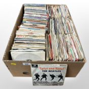 A large quantity of vinyl 7-inch singles including The Beatles, Queen, etc.