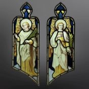 A pair of Angels holding palm branches, symbolising martyrdom, two trapezoidal stained,