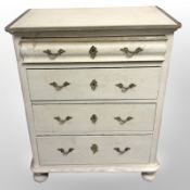 A 19th-century Scandinavian painted and gilt-pine four-drawer chest on bun feet,