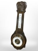 A carved oak barometer, length 55cm.
