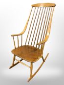 A 20th-century beech spindle back rocking armchair.