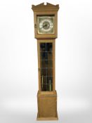 A West German blonde oak-cased longcase clock with pendulum and weights, height 198cm.