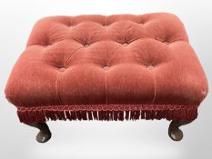 A reproduction footstool in buttoned red dralon