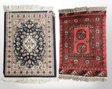 Two Afghan/Iranian hearth rugs, each approximately 49cm x 65cm.
