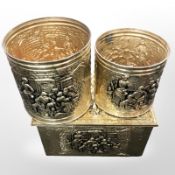 An embossed brass coal bin and two further cylindrical pots.