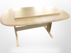 A Danish pine extending dining table with leaf,