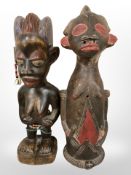 A hand-carved wooden Guro Baule maternity figure, and a similar Burkina Faso pottery figure,