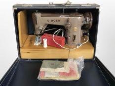 A Singer 320K electric sewing machine with lead and pedal, in case (continental plug).