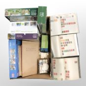 A group of jigsaws, stamps, loose and in albums, magnifying glass.