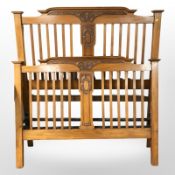 An Art Nouveau satin walnut 4'6 bed frame