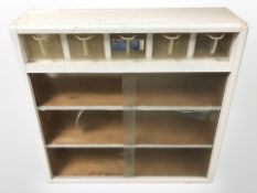 A 1950's painted sliding door bookcase,