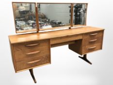 A 20th century teak and MDF mirror backed dressing table,