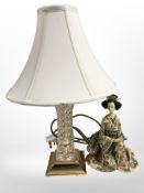 A brass and crystal lamp base, together with a Japanese resin and penwork figure of a geisha.