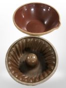 A large glazed earthenware mixing bowl, diameter 34cm, and a further jelly mould.