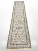 A contemporary runner, 328cm by 79cm, together with matching rug,