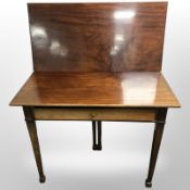 A 19th-century mahogany and oak turnover top tea table fitted a drawer, on tapering legs,