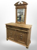 A late-19th century continental carved pine double-door sideboard on bun feet,