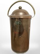 A continental brass and copper lidded urn, height 64cm including swing handle.
