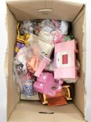 A collection of Barbie furniture and clothing.