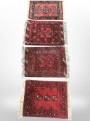 Four Afghan/Pakistani Bokhara rugs, each approximately 73cm x 50cm.