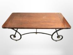 A contemporary coffee table on wrought metal stand,