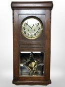 A continental oak eight-day wall clock with silvered dial, 85cm.