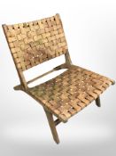 A 20th century Scandinavian teak framed chair with tan leather lattice work seats and back rests,