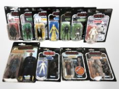 11 Kenner Star Wars figurines including The Mandalorian, The Empire Strikes Back, etc., boxed.