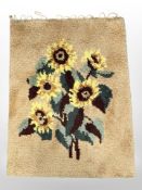 A 1970s wool rug with sunflower design, 70cm x 94cm.