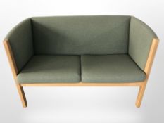 A Danish Getam Oldsted Hans J Wegner designed two seater settee in pale green fabric,