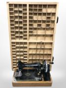 A printer's type tray together with a Singer hand sewing machine