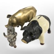 A brass money box in the form of a pig, length 27cm, and two further cast-iron money boxes.