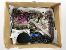 An assortment of costume bead necklaces, chokers, decorative sequined purse, etc.