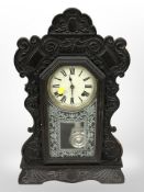 A carved and ebonised gingerbread clock, height 57cm.