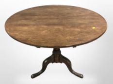 A George III oak tilt top tripod table,
