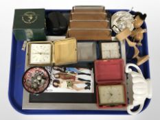 A group of travel clocks, glass photographic negatives, a 1960s teak letter rack,