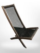 A teak framed folding garden chair with corded seat