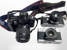 A Canon EOS 500 camera, with Canon 80-200mm zoom lens, together with a Pentax ME Super camera,
