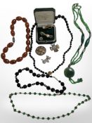 A group of costume jewellery including Scottish hardstone brooches, faceted glass bead necklaces,