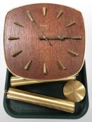 A Junghans teak and brass wall clock with pendulum and weights.