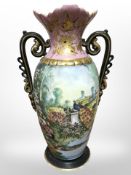 An early-20th century continental porcelain twin-handled vase, hand painted with peacocks,