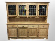 A 20th-century Danish blonde oak dresser with stained and leaded glass cabinet doors,