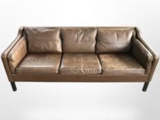 A late 20th century Danish tan leather three seater settee, length 194 cm,