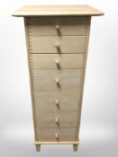 A contemporary pine seven drawer slim chest,